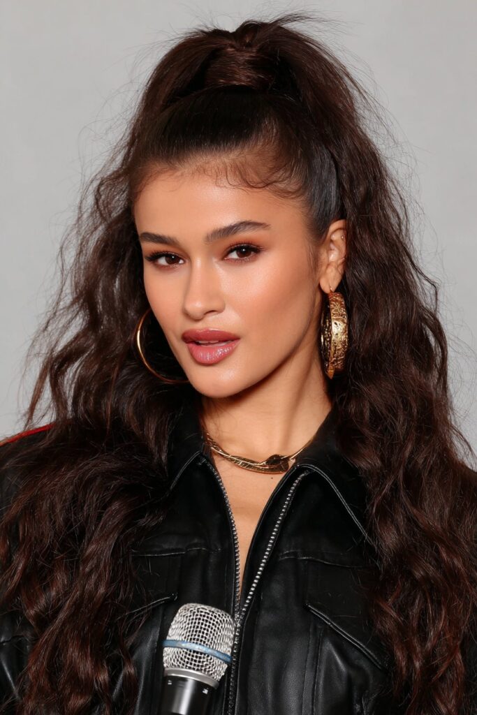 A casual messy bun hairstyle perfect for school mornings, with loose strands for a relaxed look.