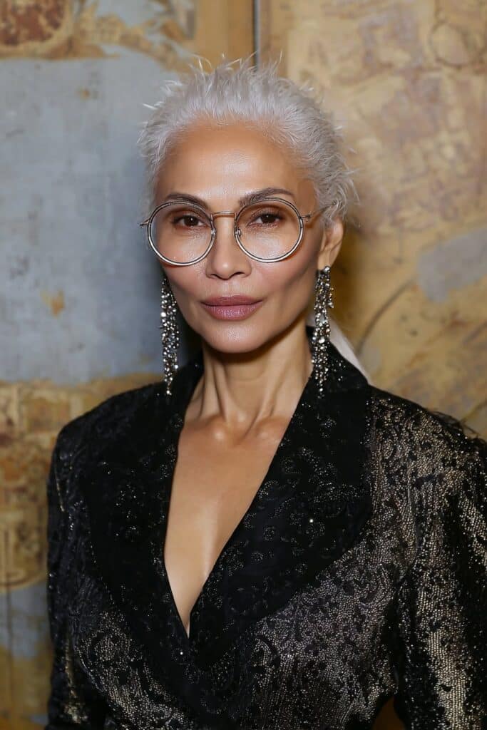 Fun-loving woman over 60 with a messy, textured pixie that adds personality and youthful energy.