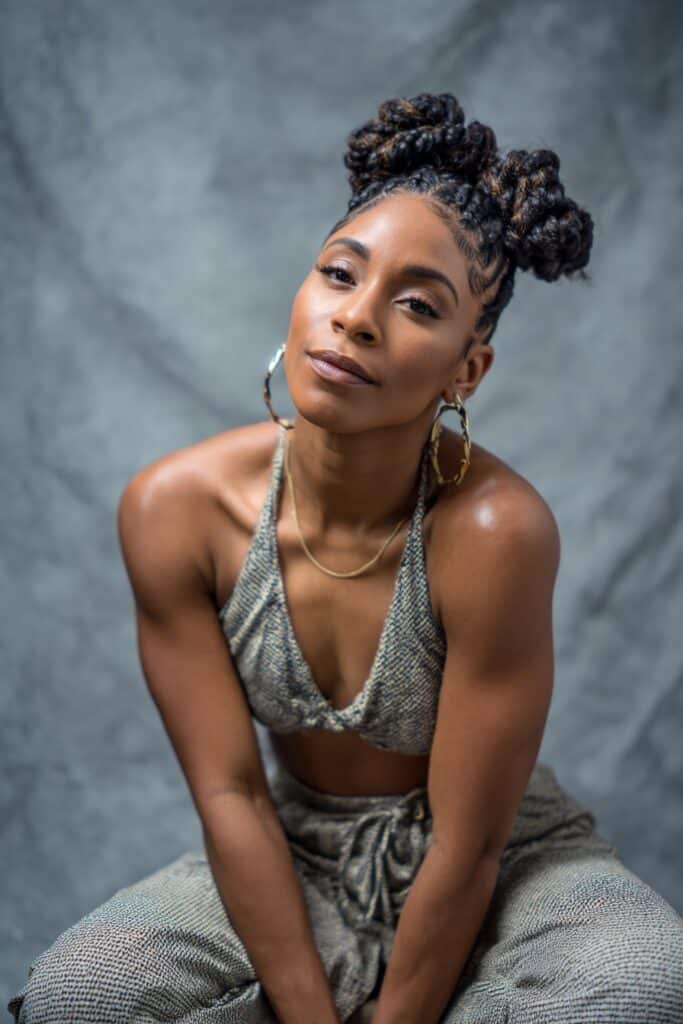 Braids or cornrows directed toward the center of the head to form a raised mohawk silhouette.