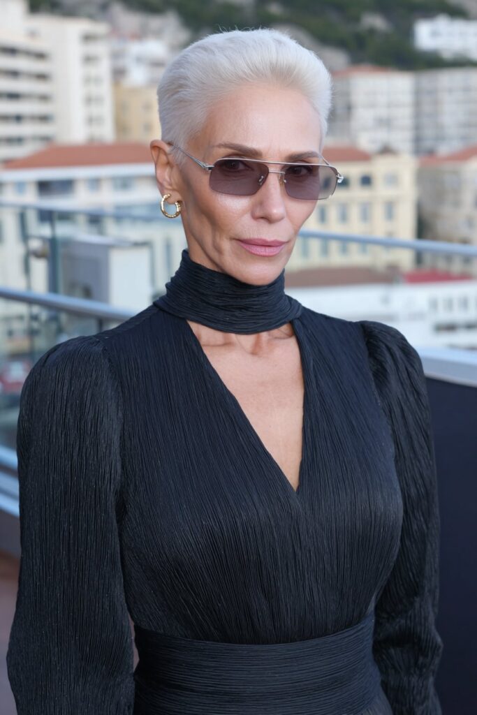 Stylish woman over 60 with a modern pixie haircut featuring asymmetrical bangs for a trendy twist.