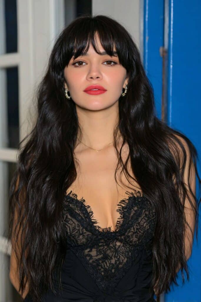 A woman with side bangs and a romantic butterfly haircut