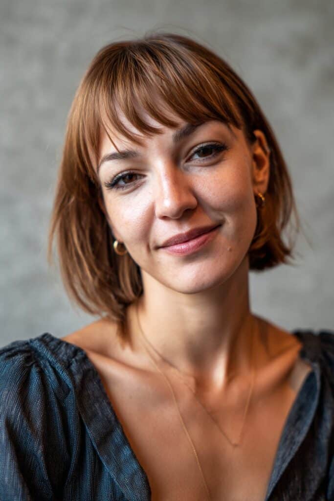 Thick hair sculpted into soft, cascading butterfly layers for a full, romantic look.