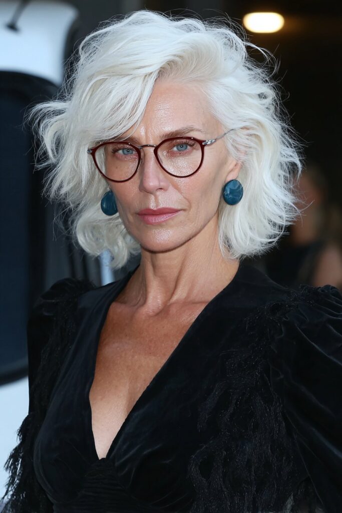 Stylish woman over 60 wearing a tousled pixie cut with shaggy layers and crown volume for a youthful, lively look.