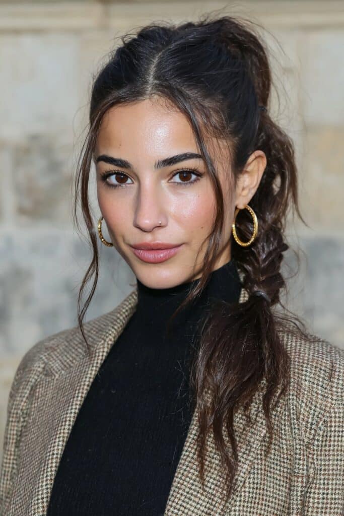 A side braid styled with a hair tie trick for a secure, quick school hairstyle.