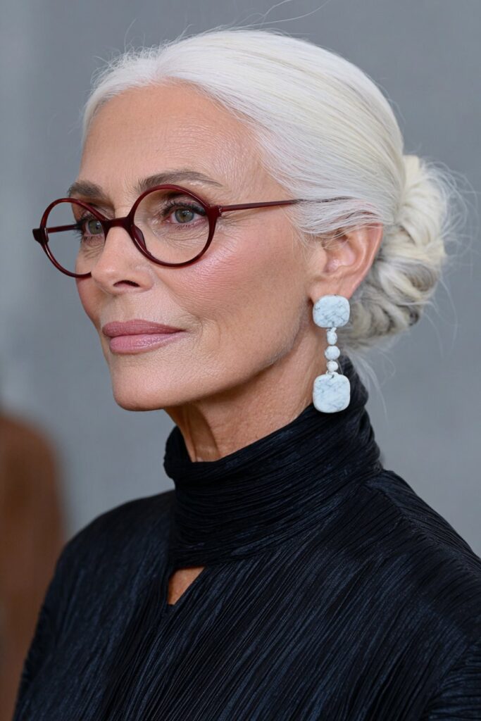 Elegant woman over 60 with a silver pixie cut and a smooth, side-swept fringe for a refined, modern style.