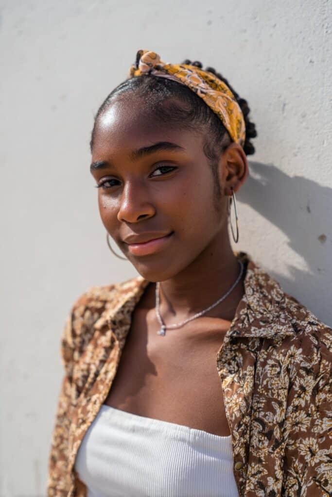 Short hair smoothed back tightly for a sleek, polished look.