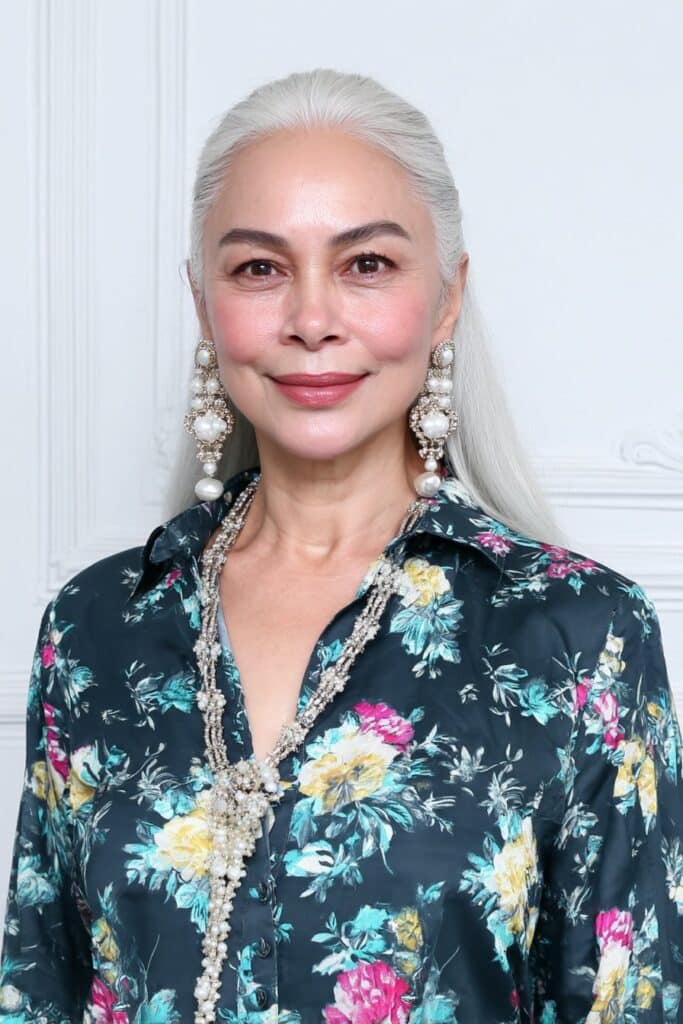 60-year-old woman with soft feathered butterfly layers showcasing light, airy volume and face-framing texture.