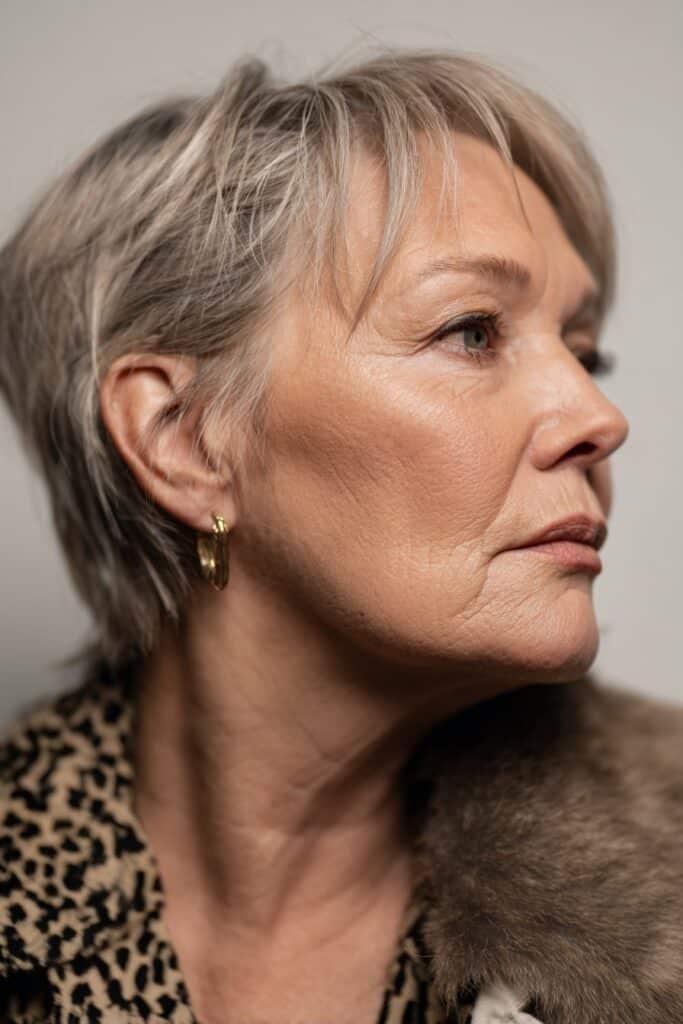 Soft layered pixie haircut with side bangs for a flattering face-framing look.