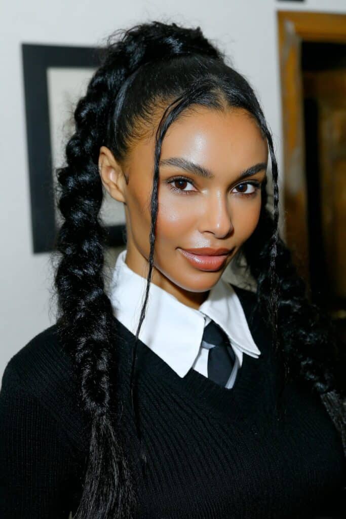 School girl wearing a beautiful halo braid around her curls, looking elegant and ready for school.