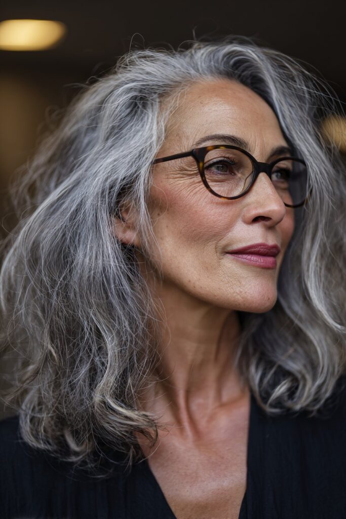 Elegant 50-year-old woman sporting a tousled lob hairstyle.