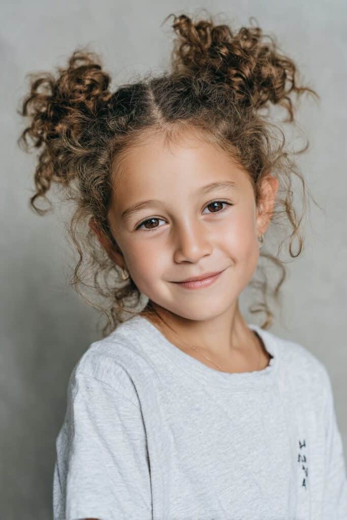 Two curly space buns