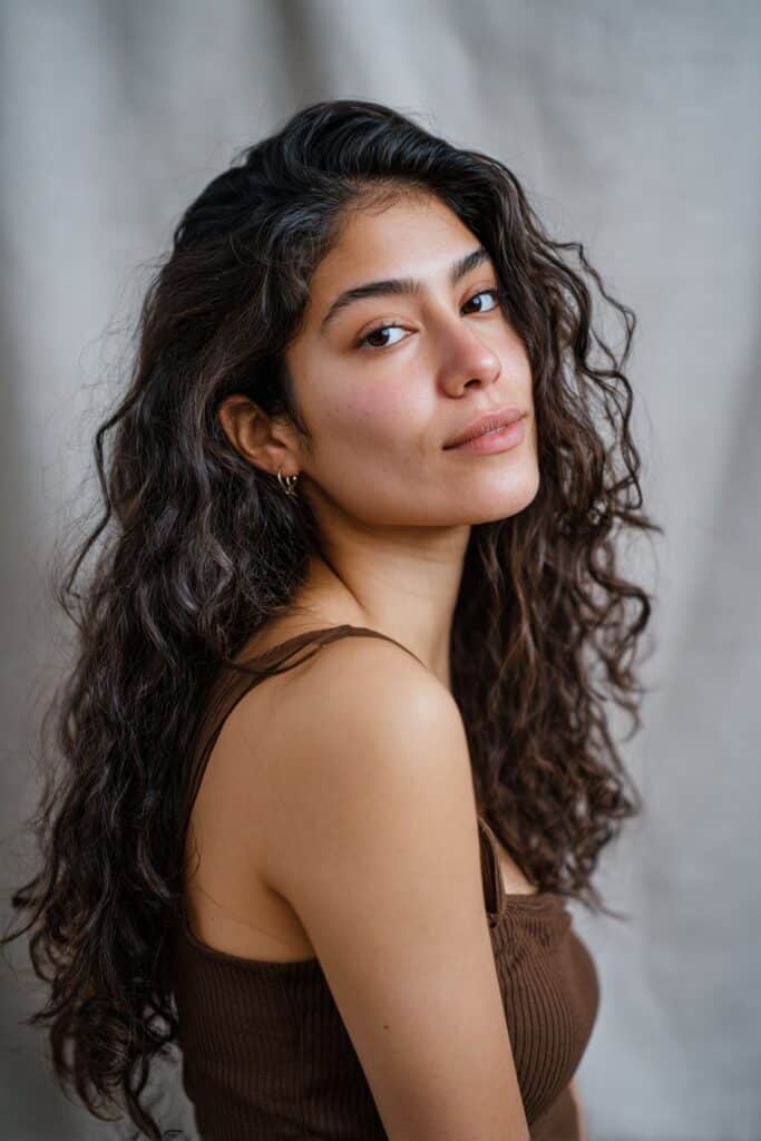 Tight, shiny ringlets shaped with curl cream for smooth, controlled definition.