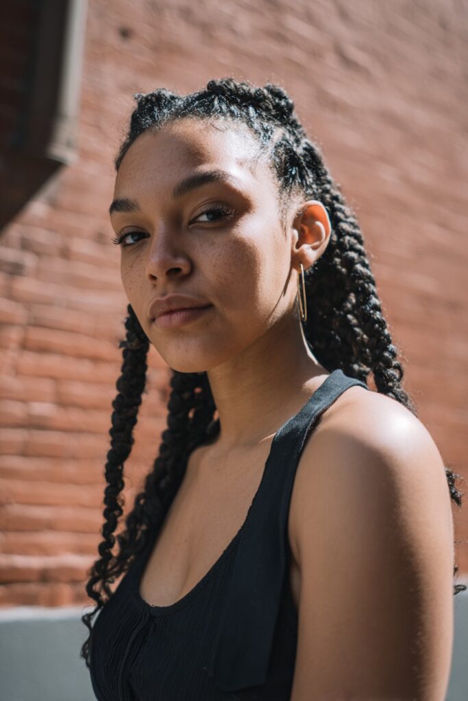 A protective style combining front cornrows with back box braids to reduce tension and maintain length.