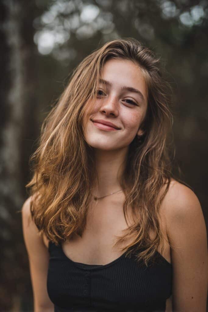 Hair divided into sections using small rubber bands, often as a prep for braiding or twisting.