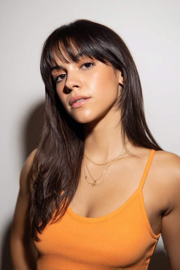 Smooth, sleek butterfly layers matched with long face-framing bangs.