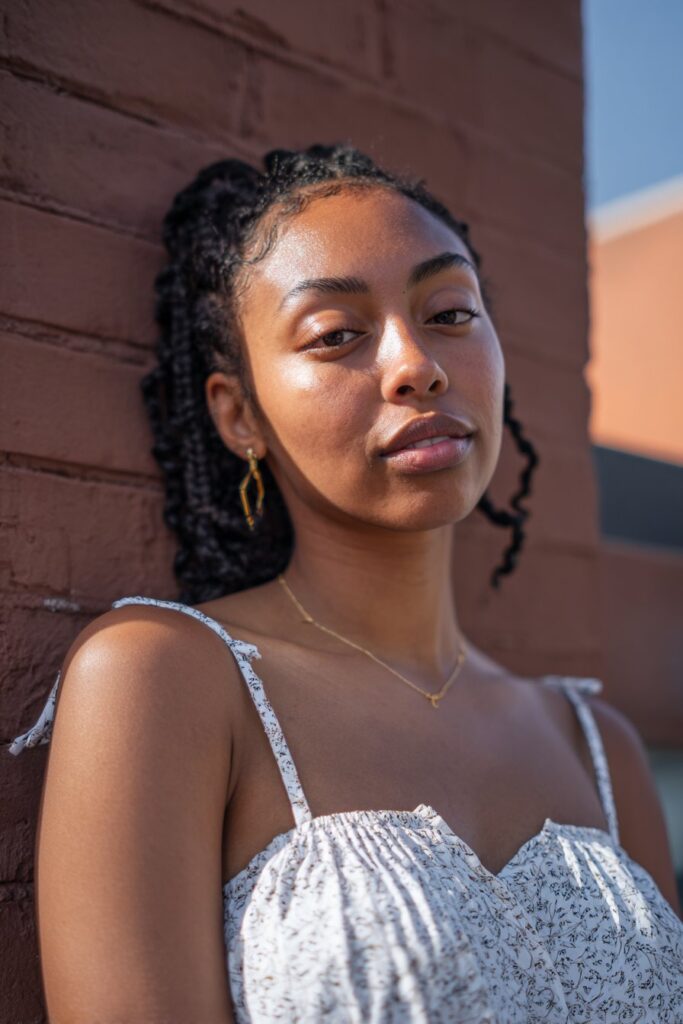 Braids are sectioned with precise horizontal “stitches,” forming crisp lines and a structured pattern.