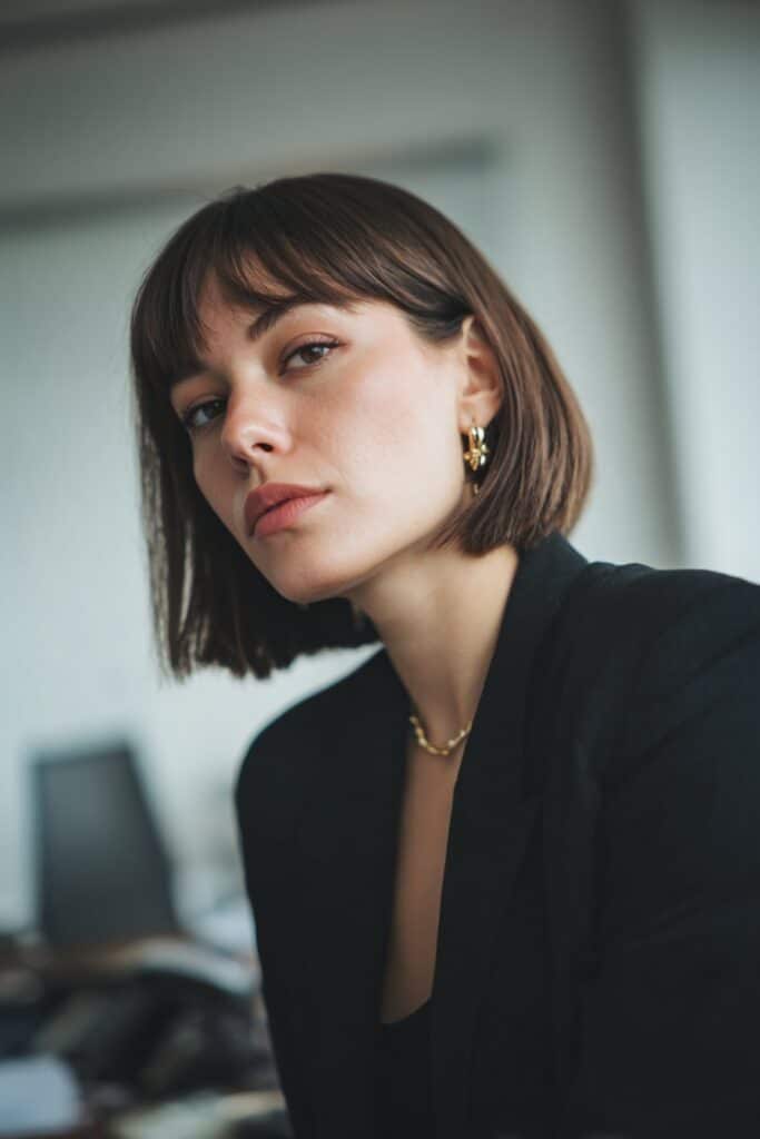 Blunt bob hairstyle with side curtain bangs on straight hair