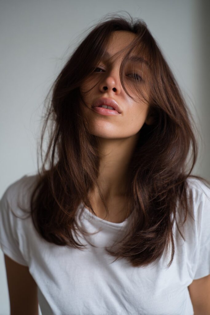 Face-framing layers with side bangs on long hair