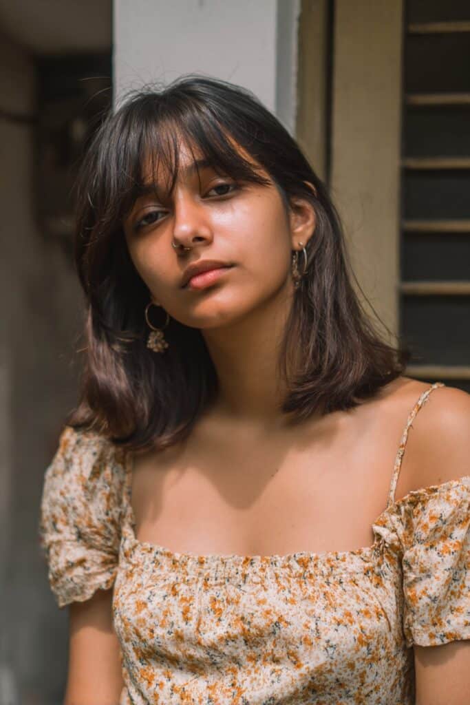 Straight medium hair with feathered side curtain bangs