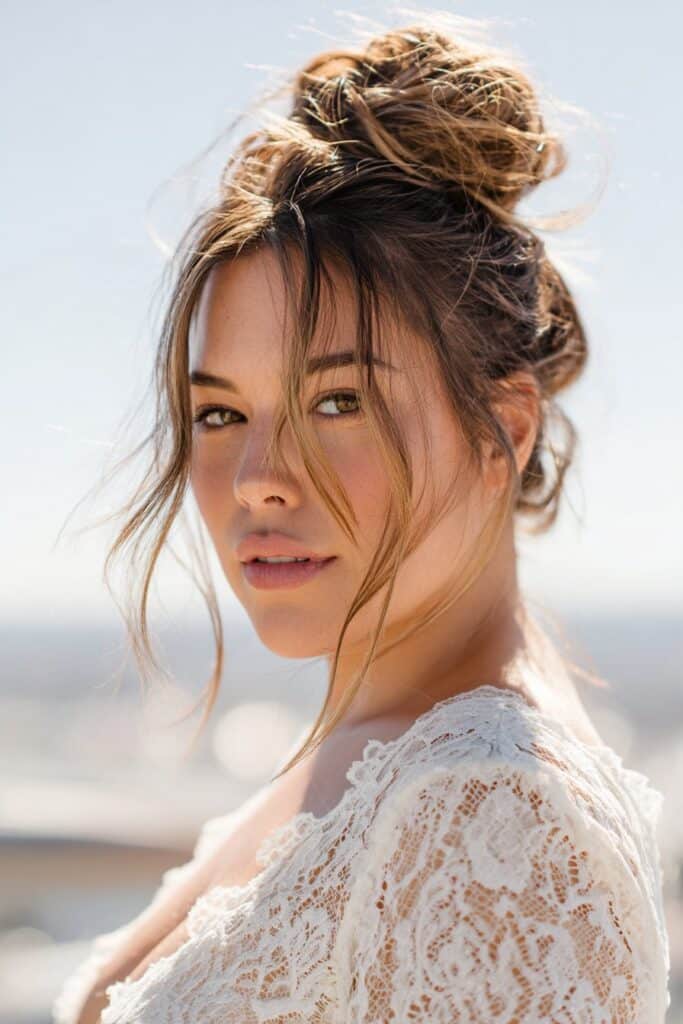 Messy bun hairstyle with face-framing strands for women