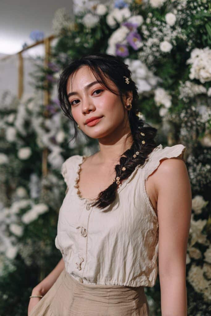 Bridesmaid side fishtail braid hairstyle with decorative accessories