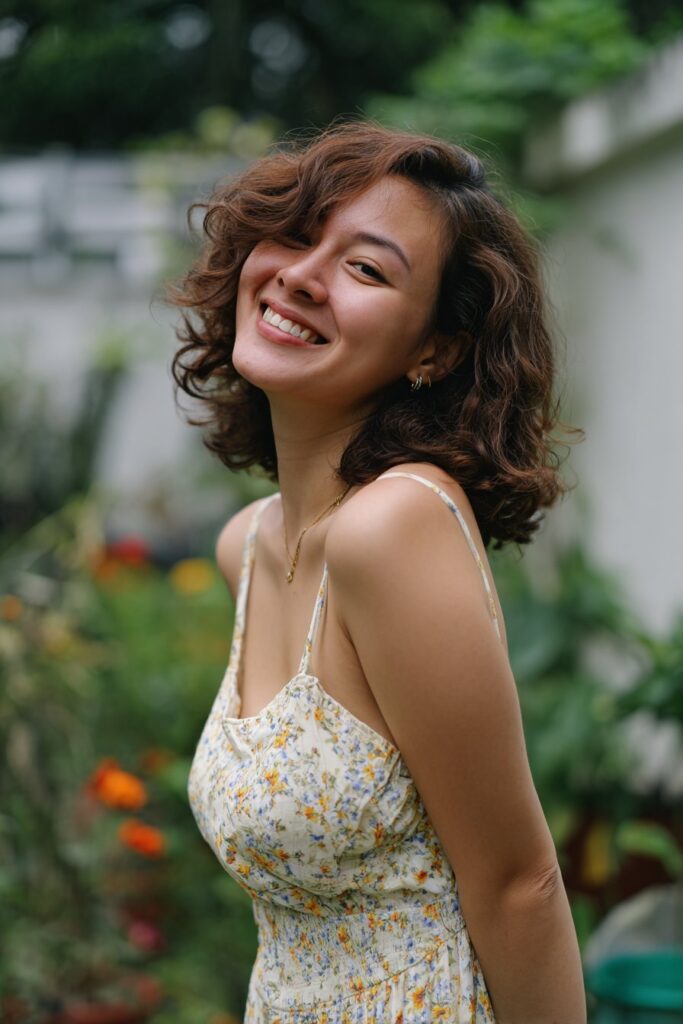 Bridesmaid side hairstyle with natural side-swept curls