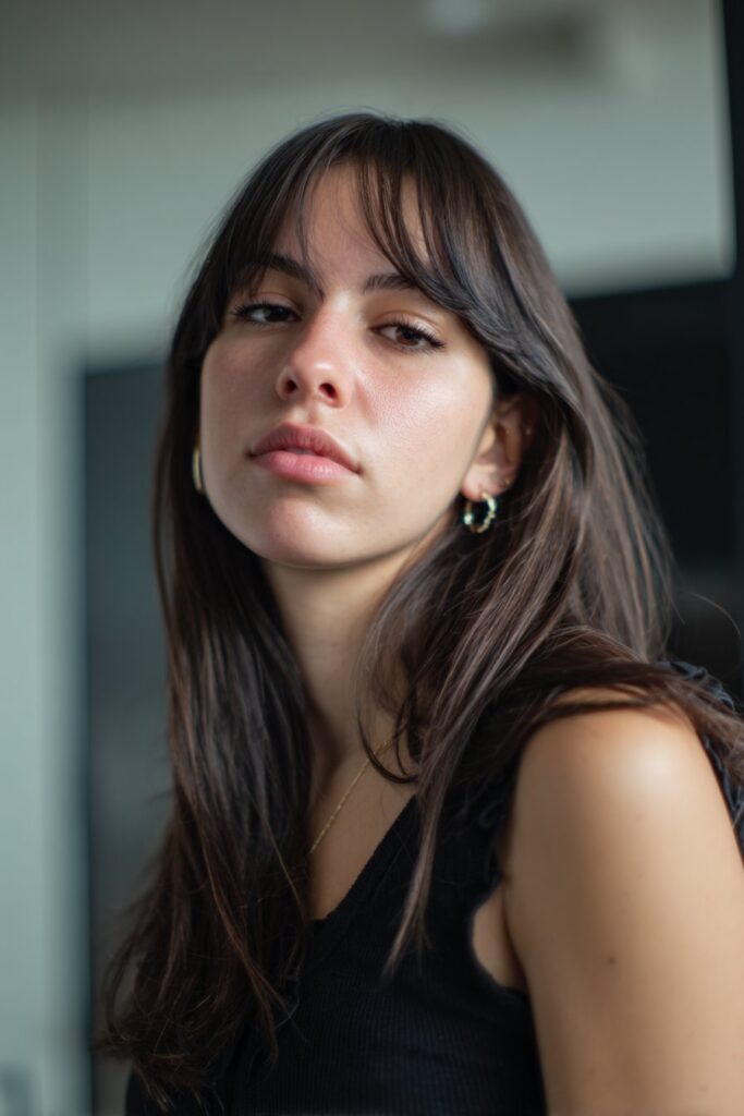 Side part curtain bangs hairstyle on straight hair with long layers