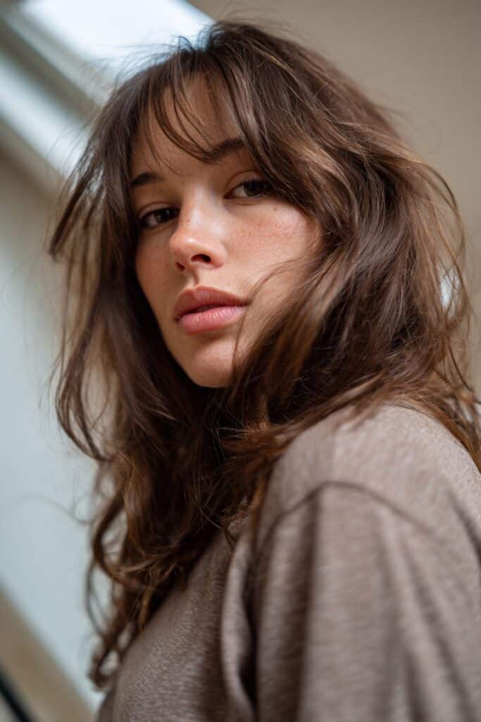 Textured mid-length layered haircut for women.