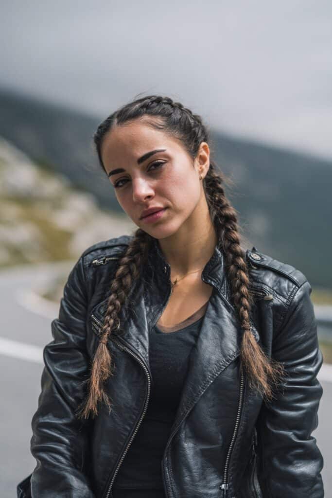 Two braids hairstyle for female biker with sleek finish