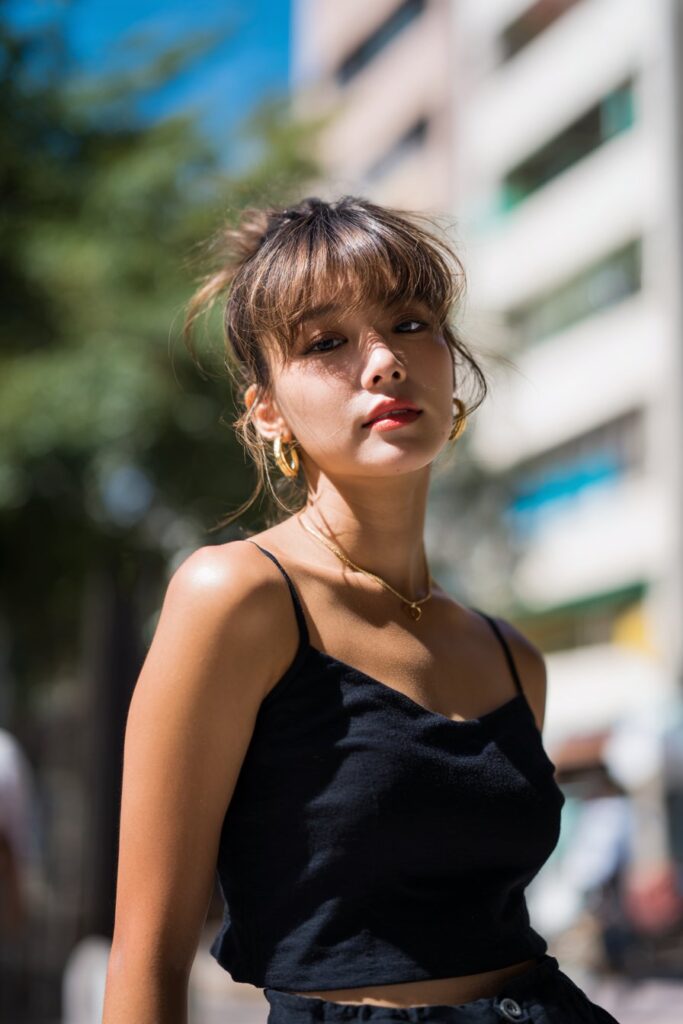 Straight hair with wispy side curtain bangs and subtle highlights