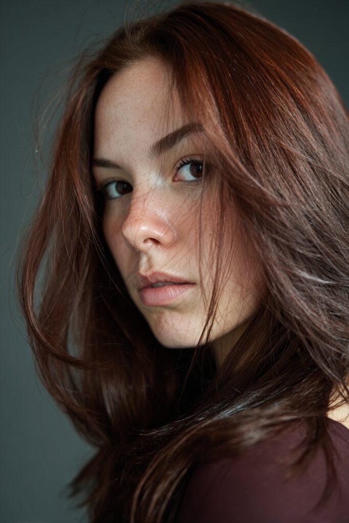 Dark auburn hair with reddish undertones for hazel eyes