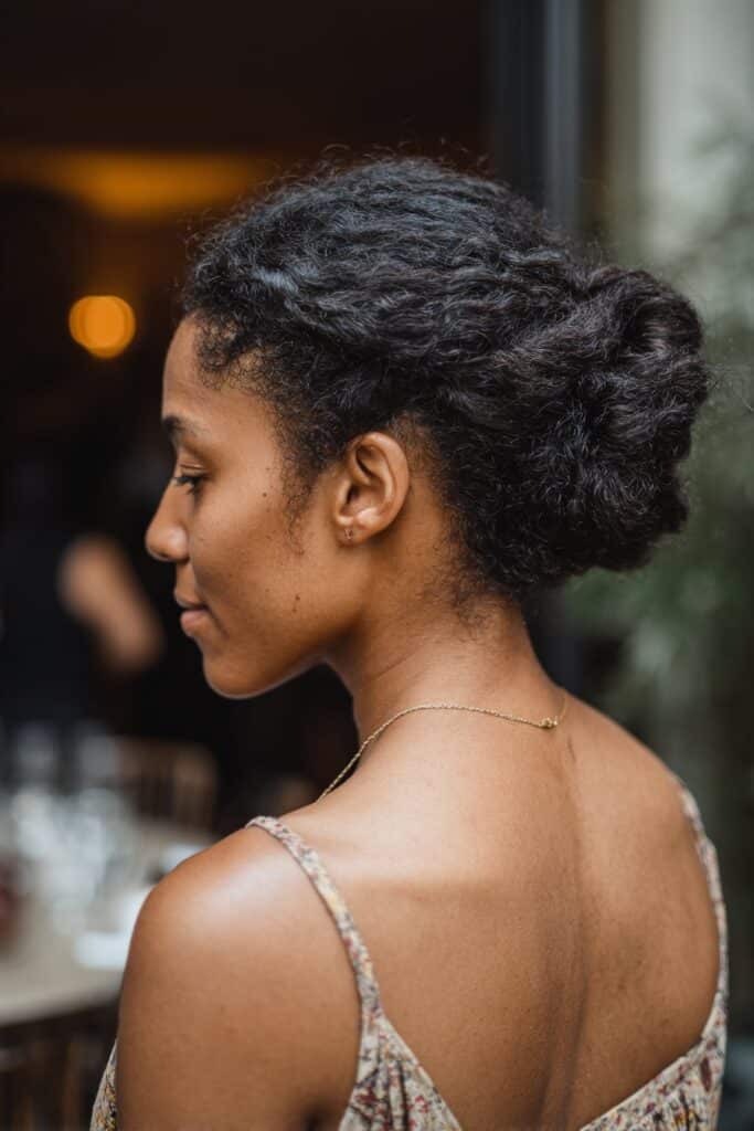 Low twisted chignon updo hairstyle for wedding guest