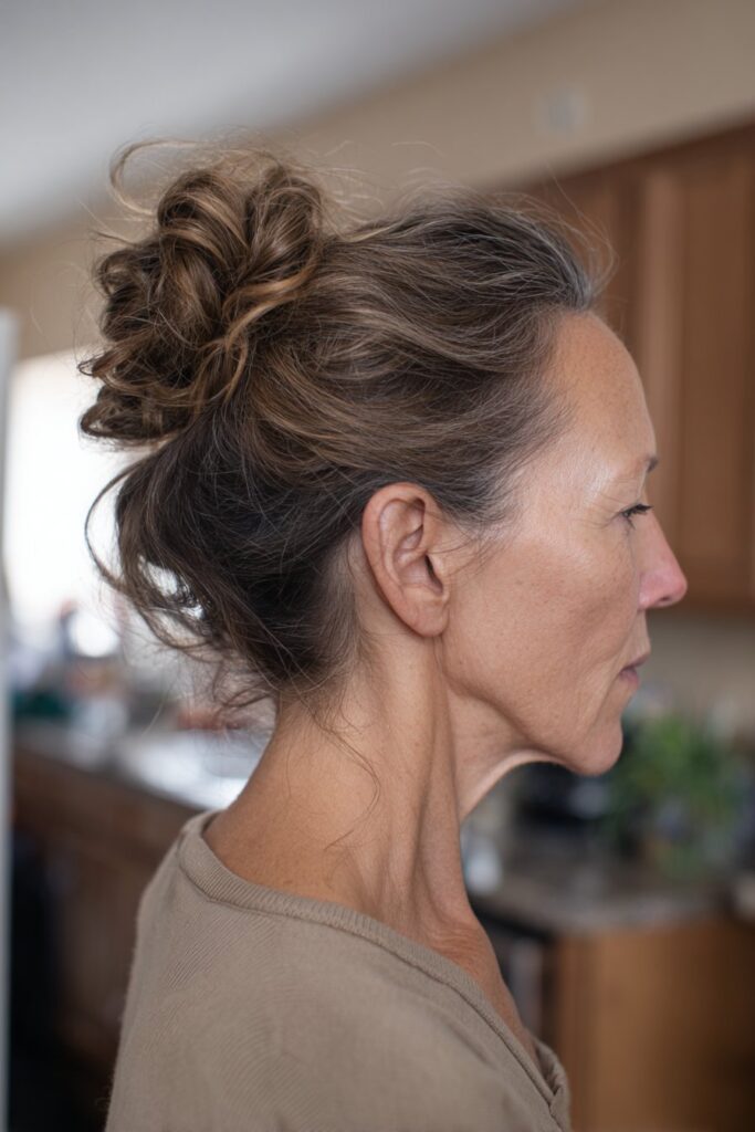 Messy bun with tendrils easy hairstyle for older women with long hair