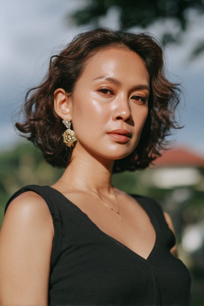 Natural curls with statement earrings engagement hairstyle for short hair