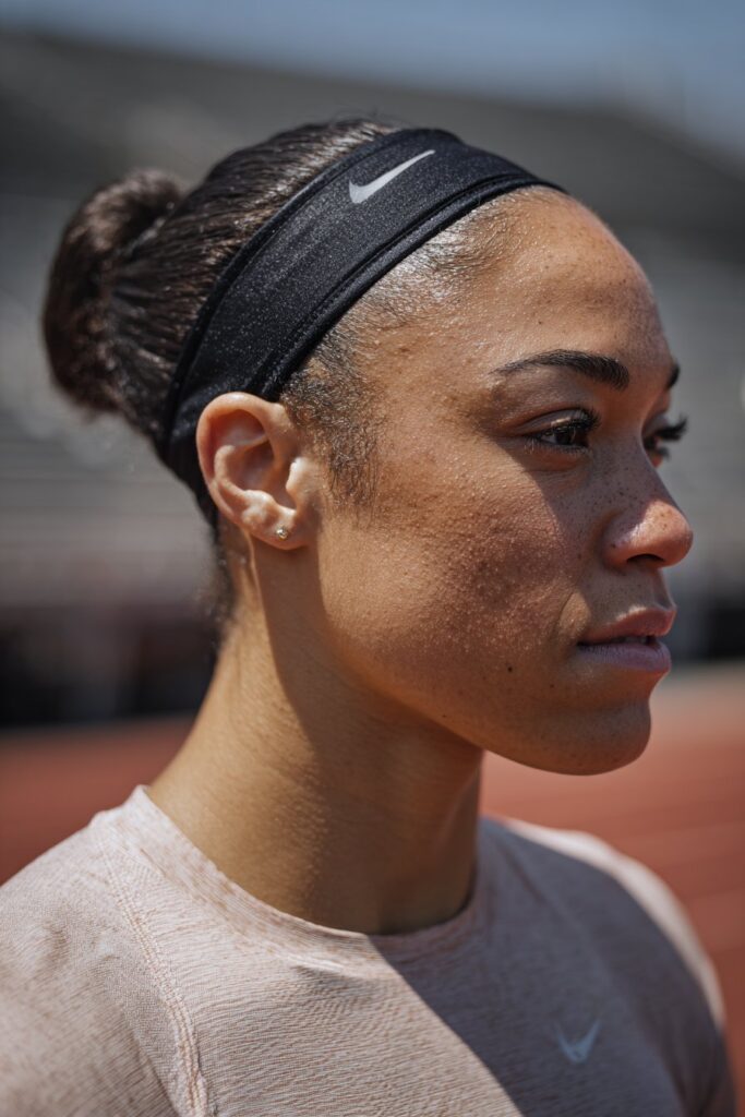 Sleek low bun with headband track day hairstyle