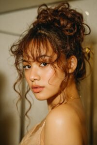 Voluminous Curled Updo with Soft Texture