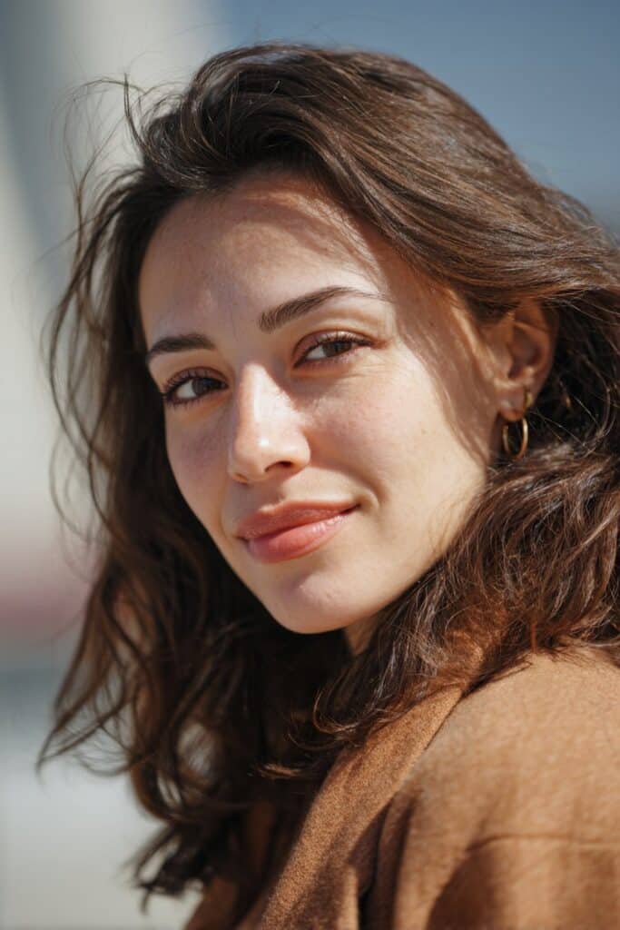 Warm dimensional brunette hair color with blended highlights