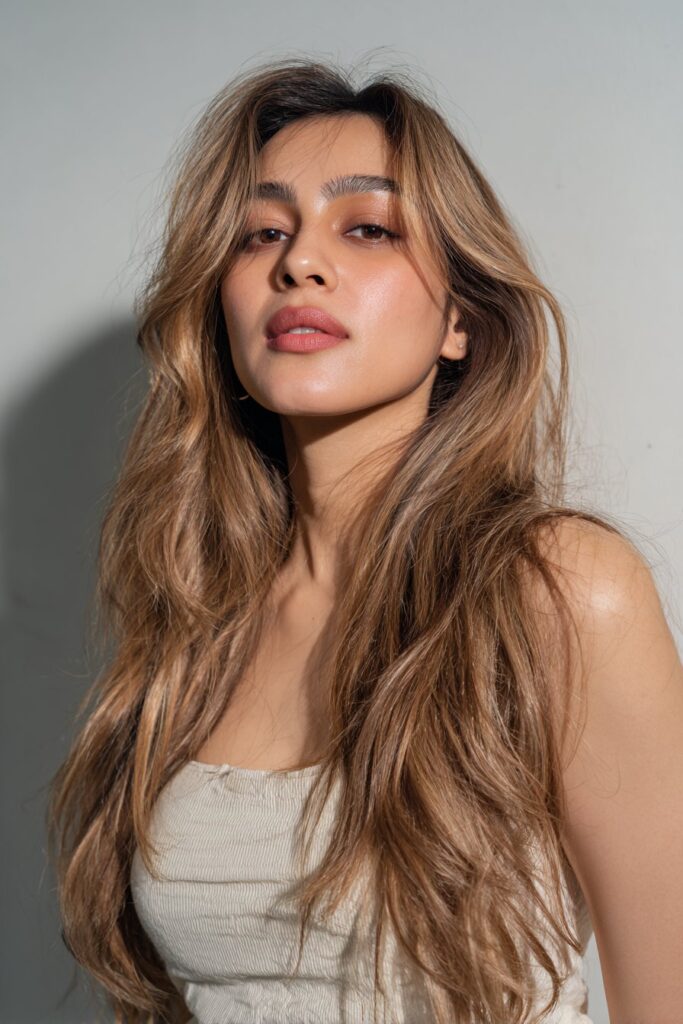 Blonde highlights on dark brown hair with natural contrast