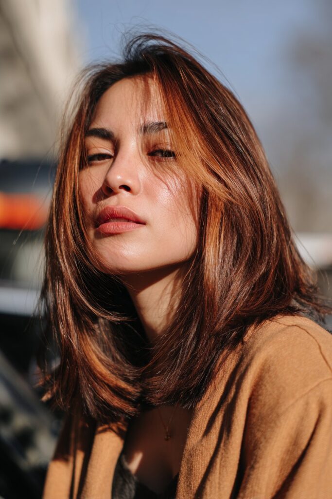 Copper balayage highlights on dark brown hair