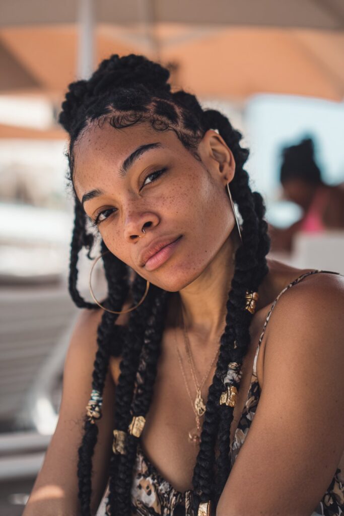 Fulani braids on Black woman, cultural and chic vacation hairstyle