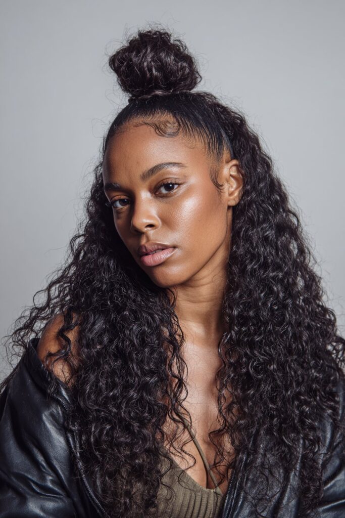 Half-up curly bun hairstyle for Black women
