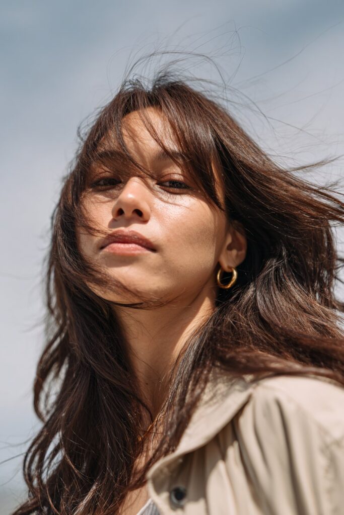 Medium layered haircut with long curtain bangs