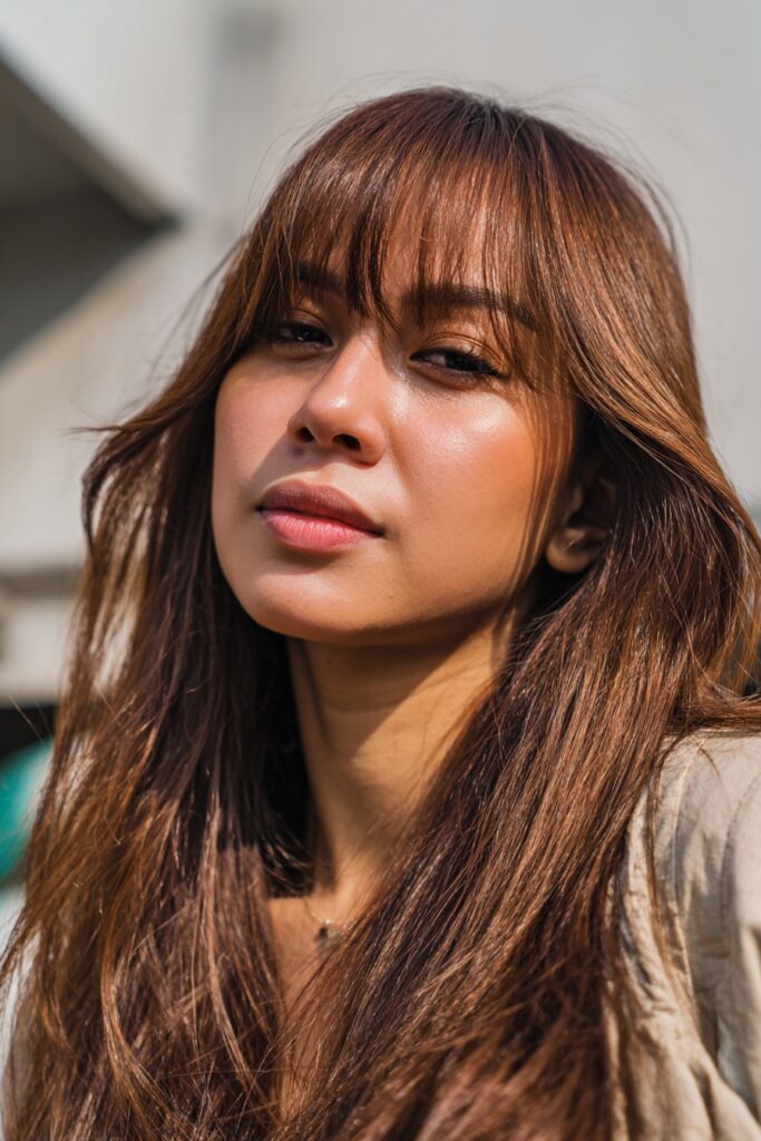 Long layered curtain bangs with blended face framing layers