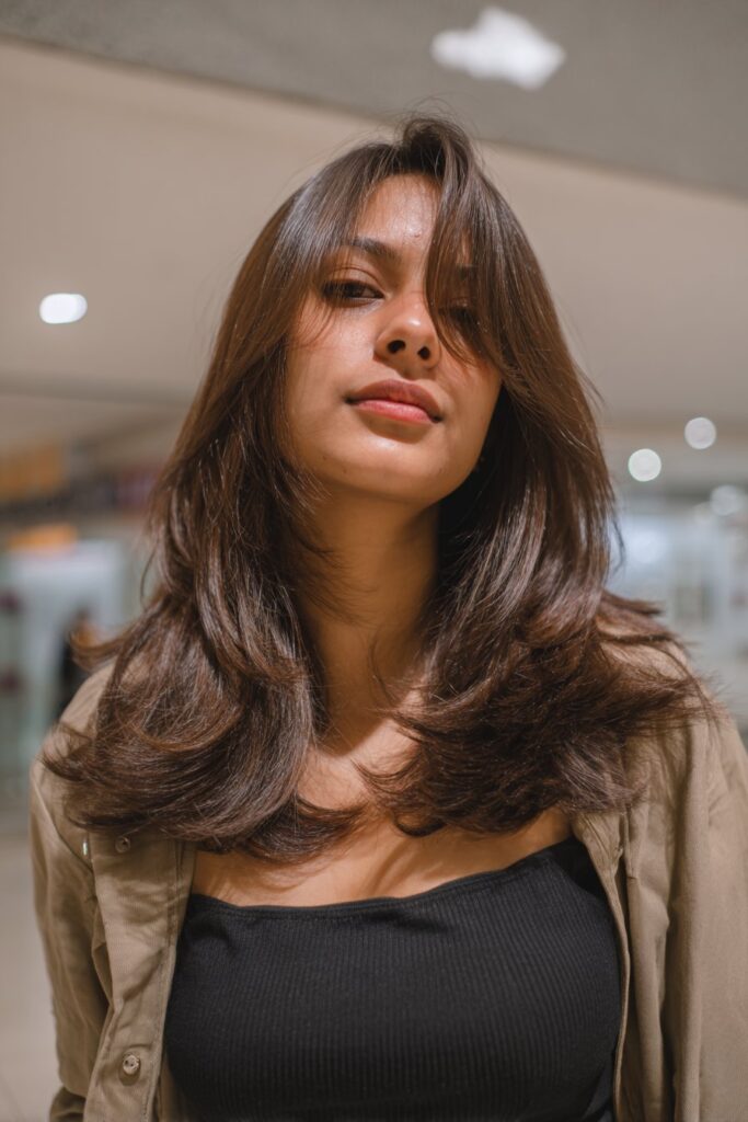 Medium length layered lob haircut with soft movement