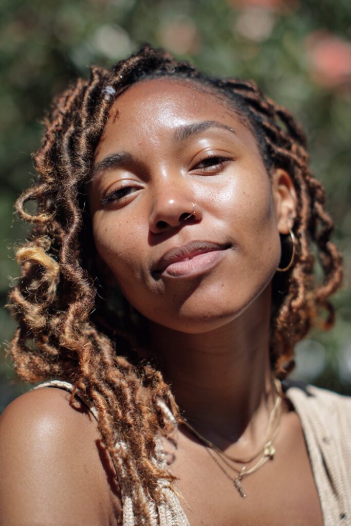 Natural textured locs with warm tones spring hairstyle for Black women