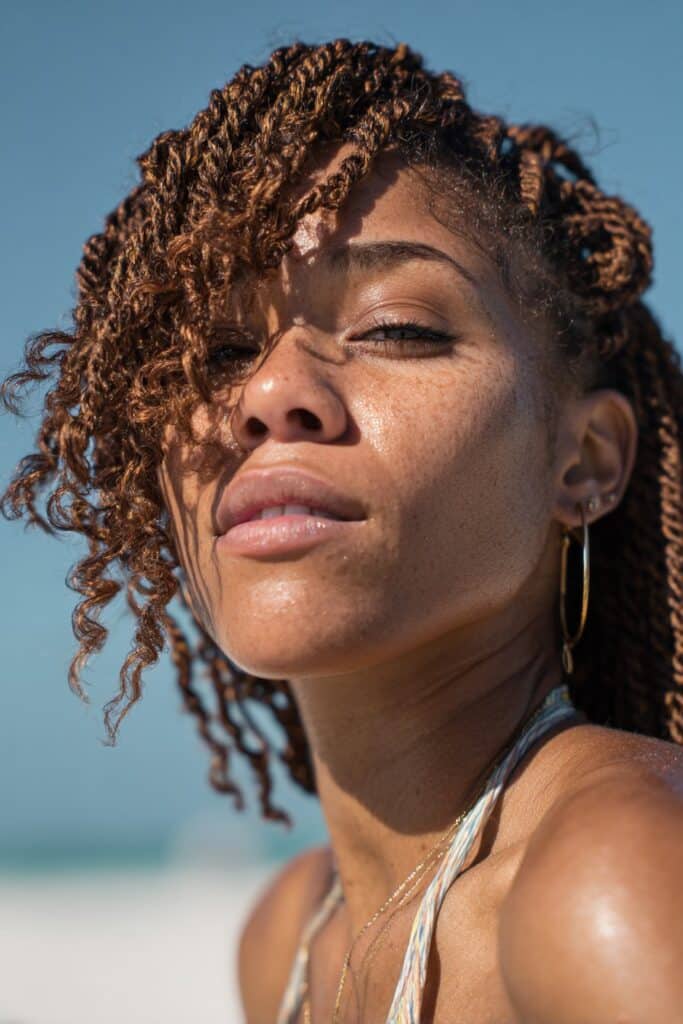 Passion twists on Black woman, flirty vacation hairstyle with movement