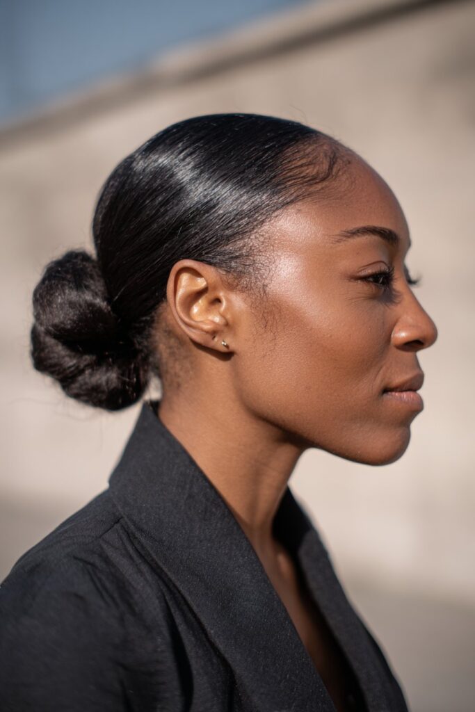 15 Gorgeous Black Hair Updo Hairstyles to Try Today 2 Sleek low chignon updo for Black hair