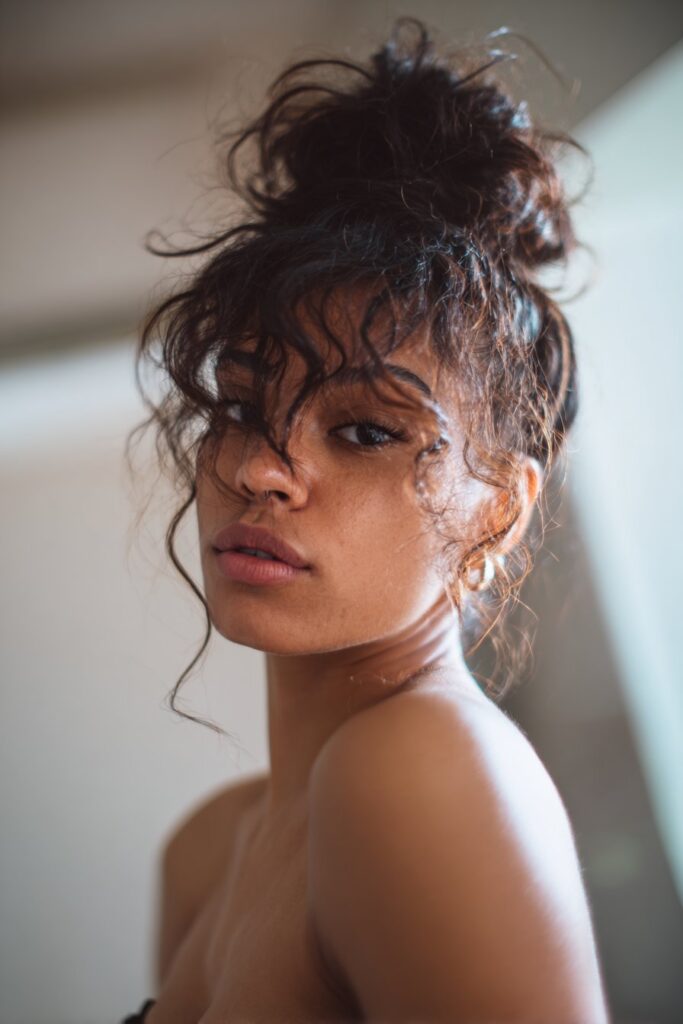 Prom updo hairstyle black hair messy updo face framing