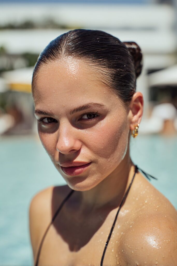 Pool party hairstyles sleek low bun"