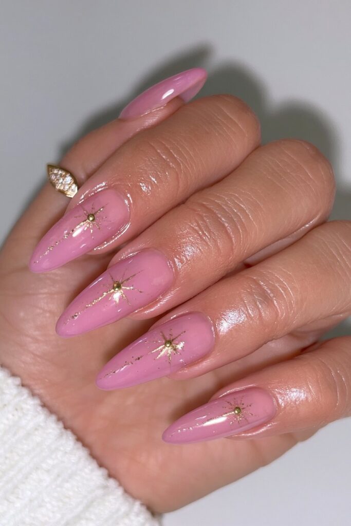 Pink nude nails with gold constellations
